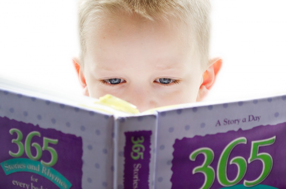 baby boy reading a book